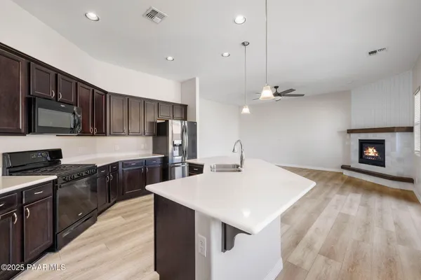a kitchen with a stove a sink and a refrigerator
