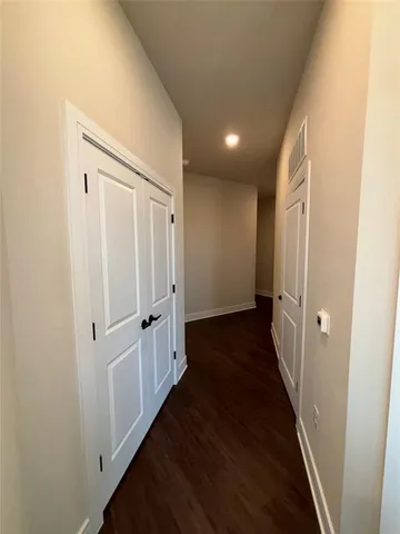 a view of a hallway with white walls