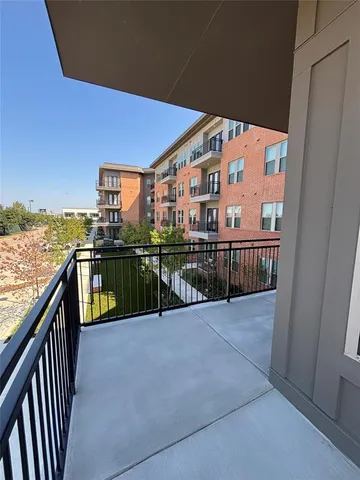 a view of a patio with lawn chairs