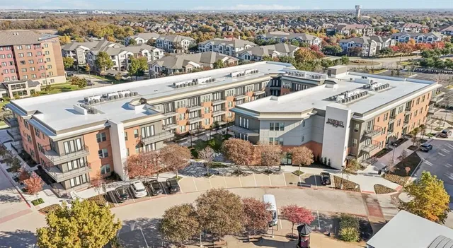 an aerial view of residential building and parking space