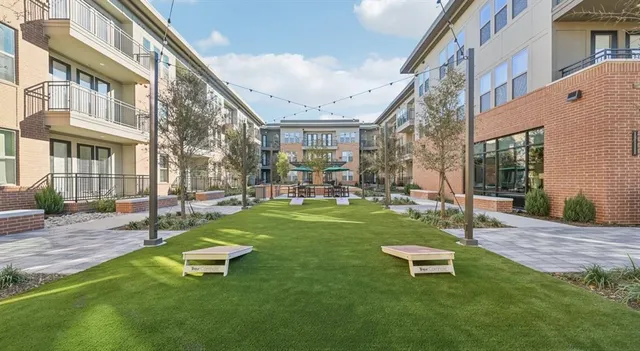 a view of a white building with couches in front of building