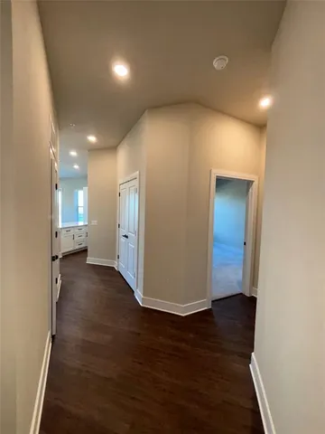 a view of a hallway with wooden floor