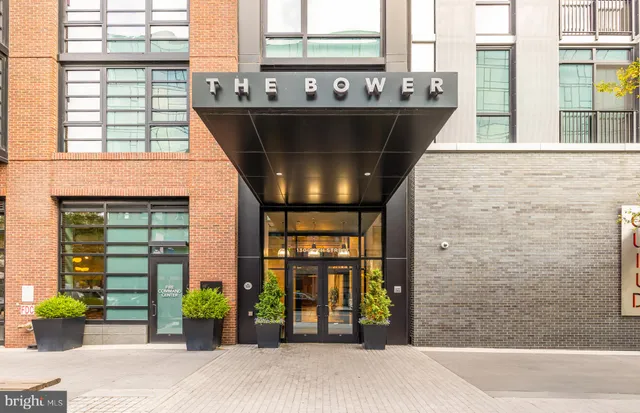 a front view of a building with outdoor seating