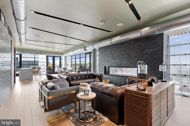 a living room with furniture fireplace and a flat screen tv