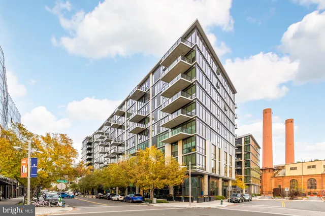 a view of a city street lined with buildings and trees