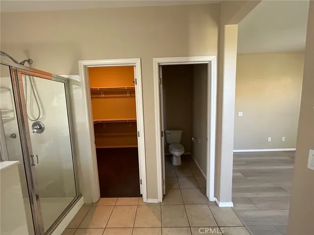 a bathroom with a shower and a toilet
