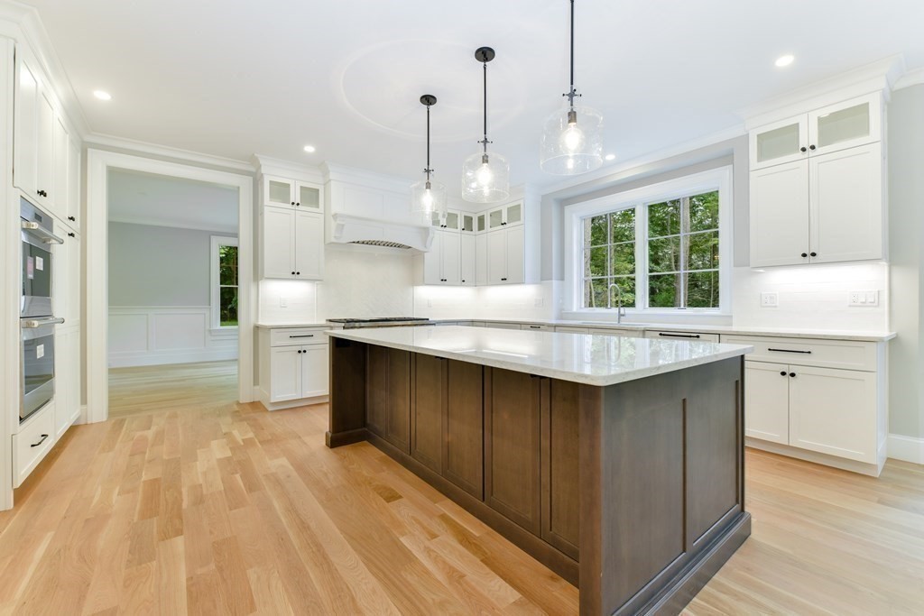 Lot 25 Leewood Road Wellesley, MA 02482 - Photo 17 of 40 a kitchen with granite countertop a sink cabinets and wooden floor