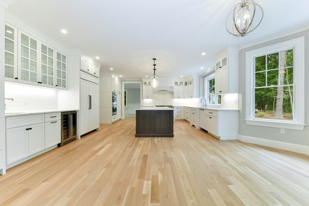 Lot 25 Leewood Road Wellesley, MA 02482 - Photo 19 of 40 a large kitchen with a lot of white cabinets a sink dishwasher and a stove with wooden floor