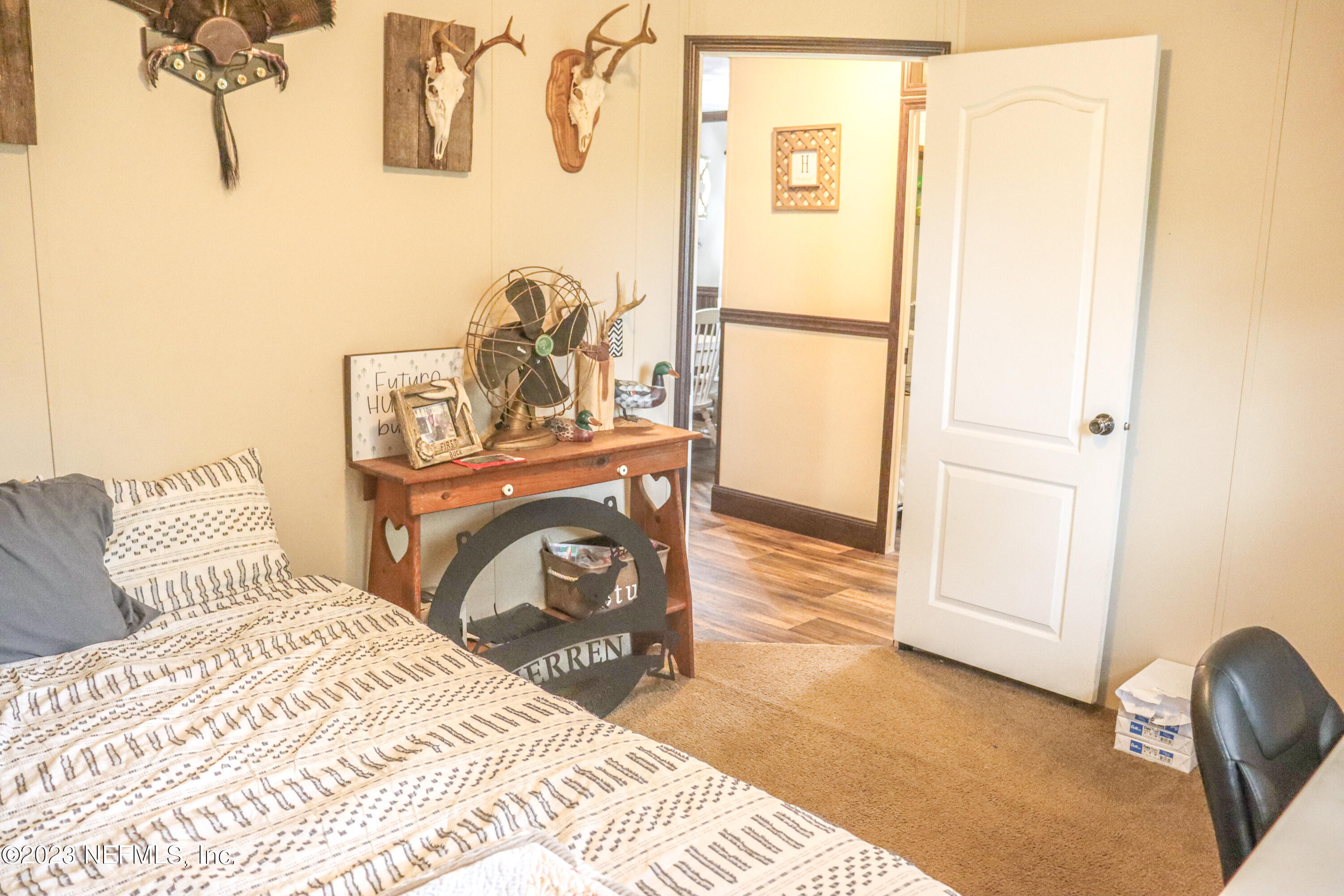 447689 Us Highway Callahan, FL 32011 - Photo 15 of 37 a bedroom with a bed and a mirror