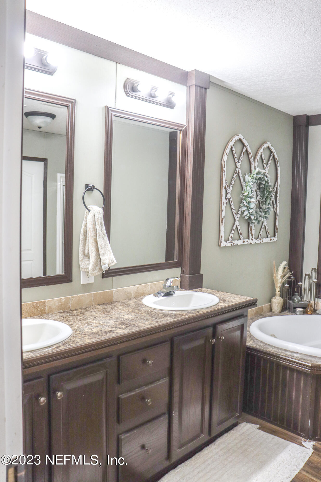 447689 Us Highway Callahan, FL 32011 - Photo 20 of 37 a bathroom with a granite countertop sink and a mirror