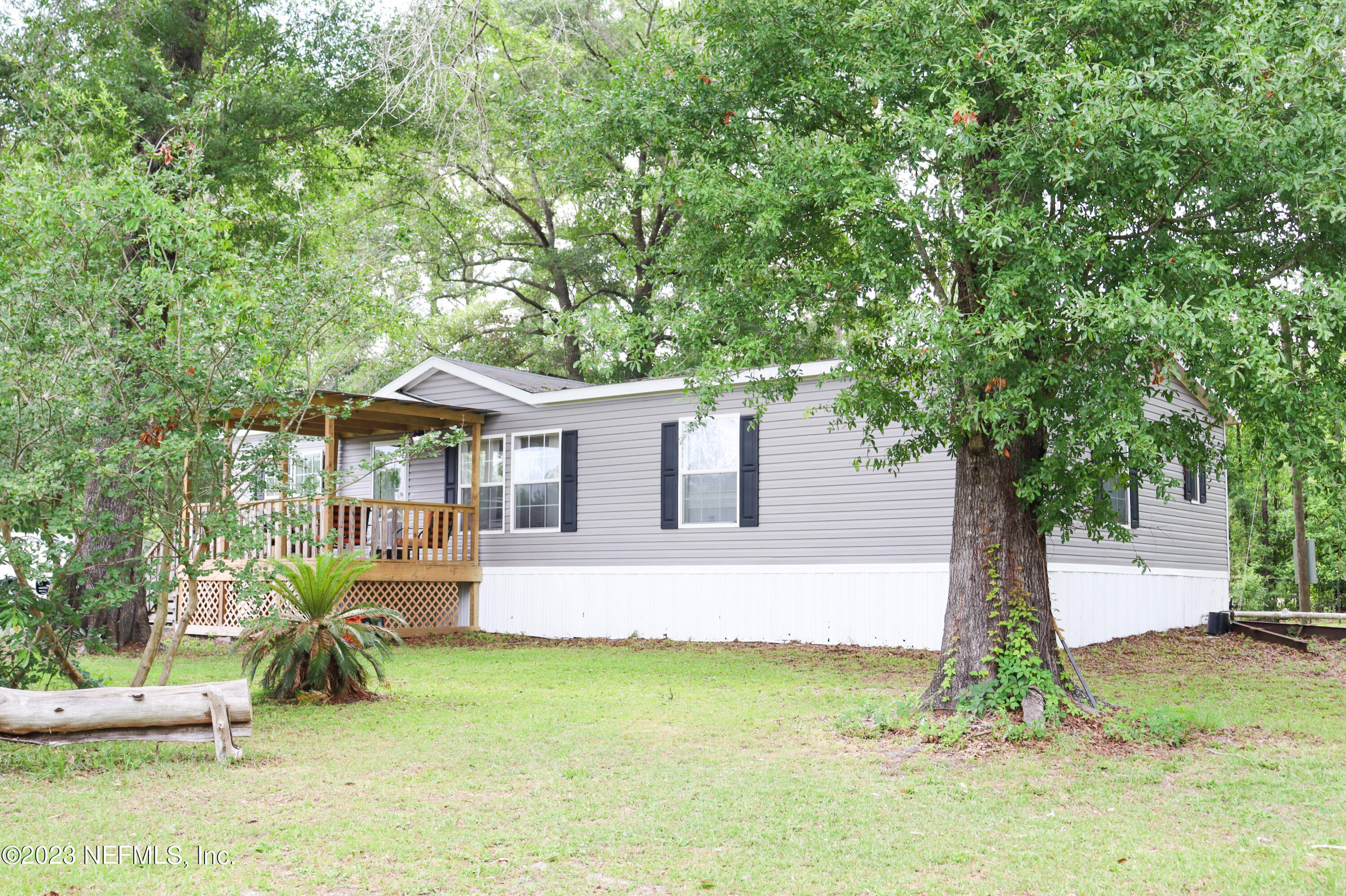 447689 Us Highway Callahan, FL 32011 - Photo 2 of 37 a front view of house with yard and trees