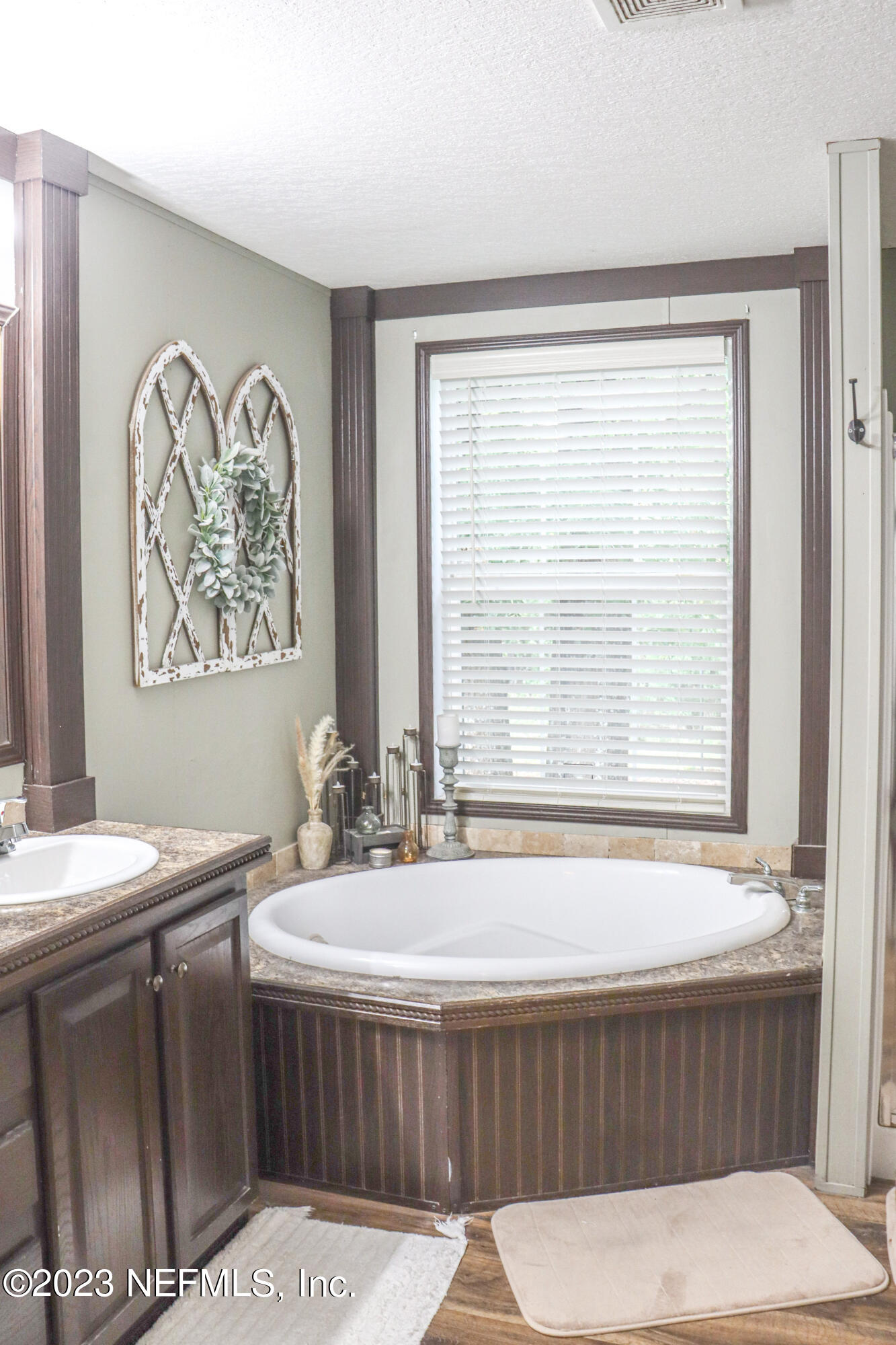 447689 Us Highway Callahan, FL 32011 - Photo 21 of 37 a bathroom with a tub a sink and a large window