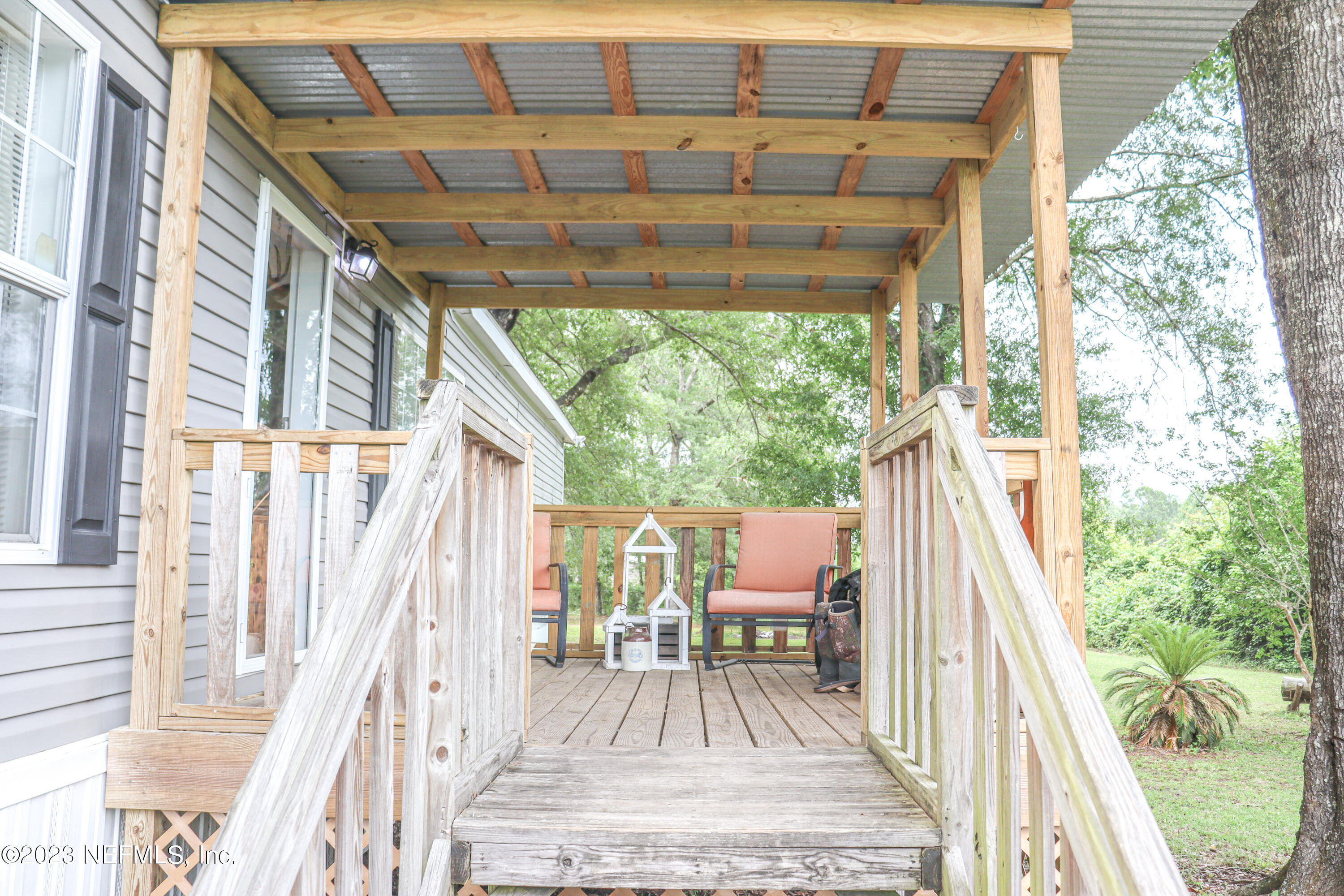 447689 Us Highway Callahan, FL 32011 - Photo 24 of 37 a view of balcony with wooden floor and outdoor seating