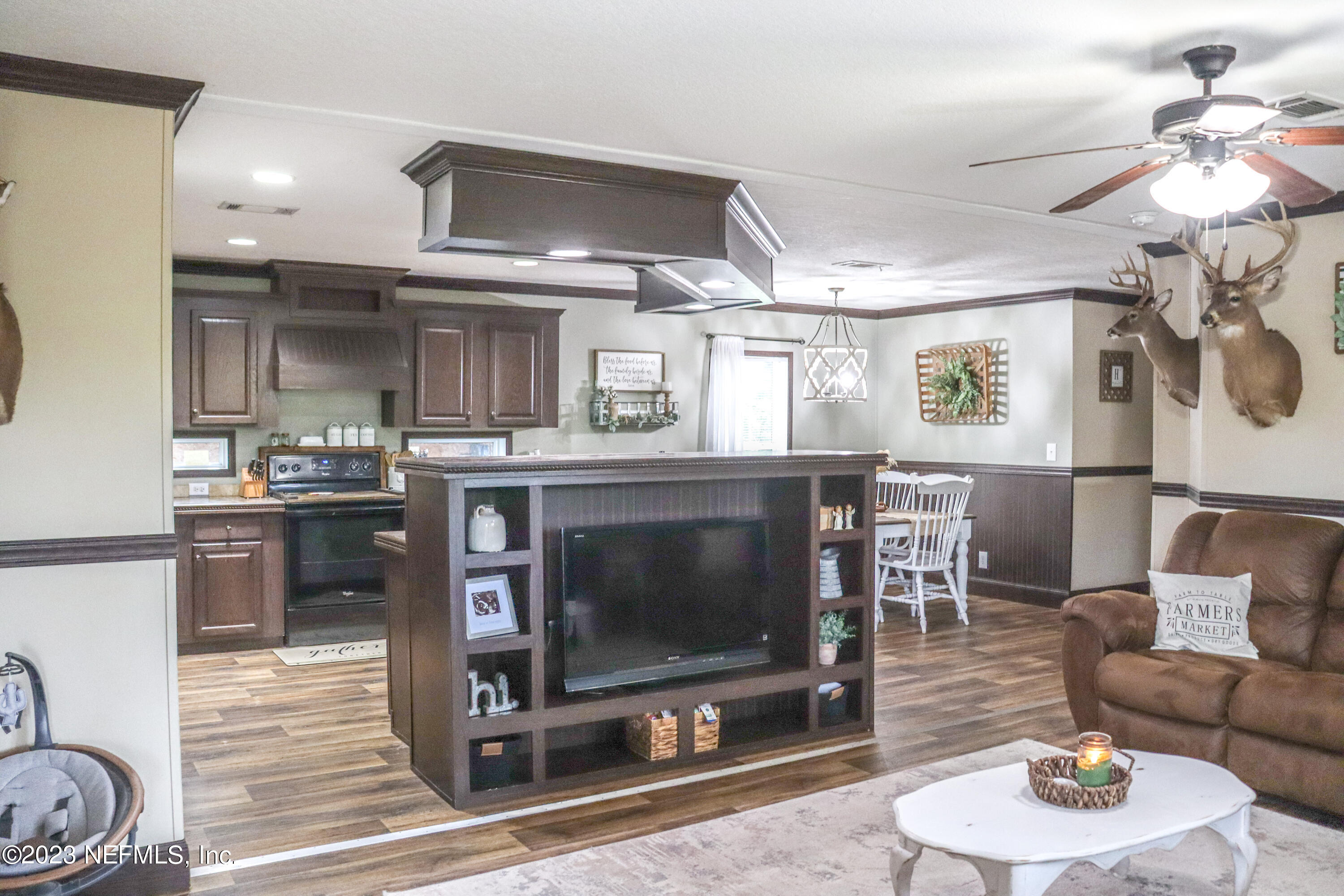 447689 Us Highway Callahan, FL 32011 - Photo 4 of 37 a living room with furniture a fireplace and a chandelier