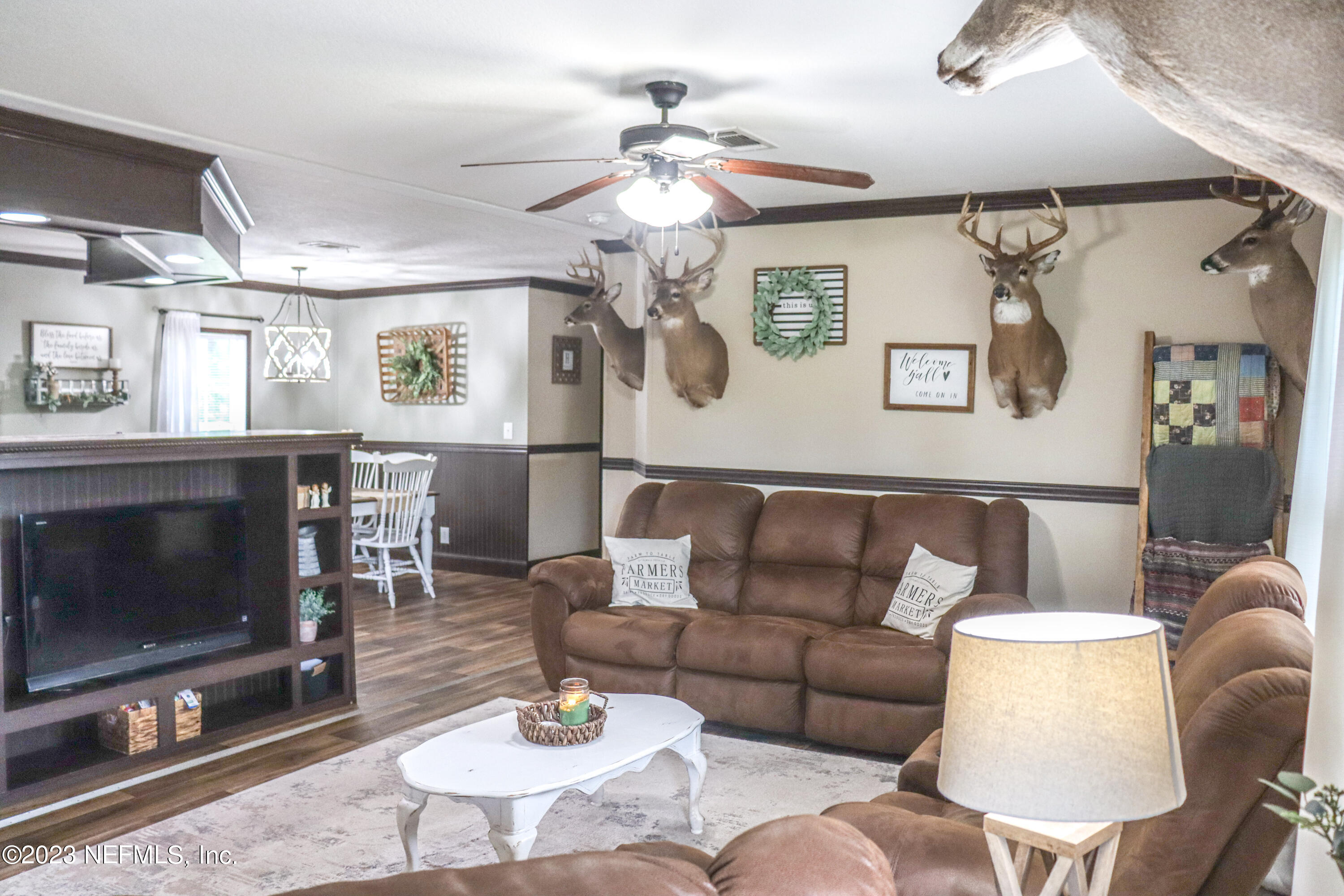 447689 Us Highway Callahan, FL 32011 - Photo 5 of 37 a living room with furniture a fireplace and a flat screen tv