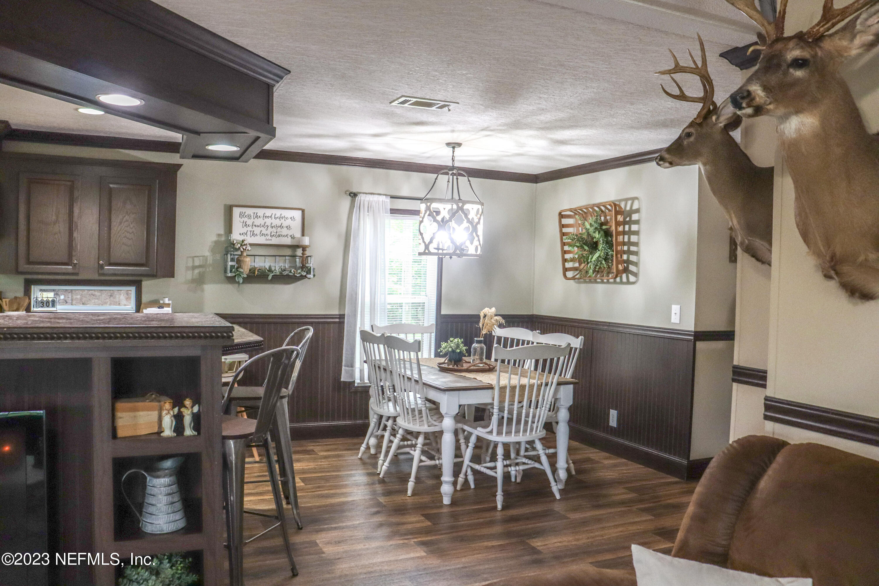 447689 Us Highway Callahan, FL 32011 - Photo 8 of 37 a view of a dining room with furniture and wooden floor