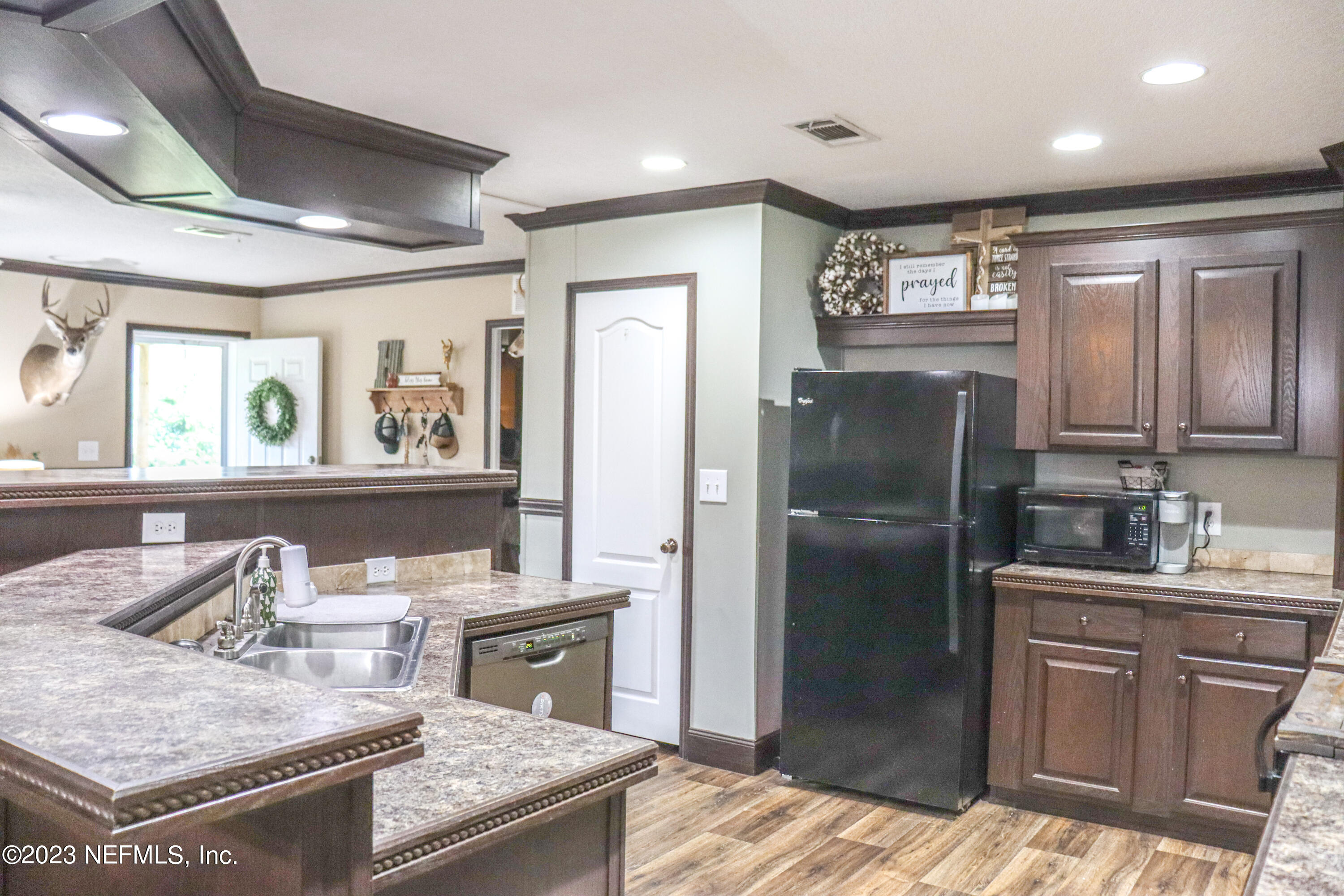 447689 Us Highway Callahan, FL 32011 - Photo 10 of 37 a kitchen with stainless steel appliances granite countertop a refrigerator a stove and a sink