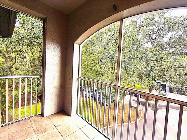 an empty room with fan and windows