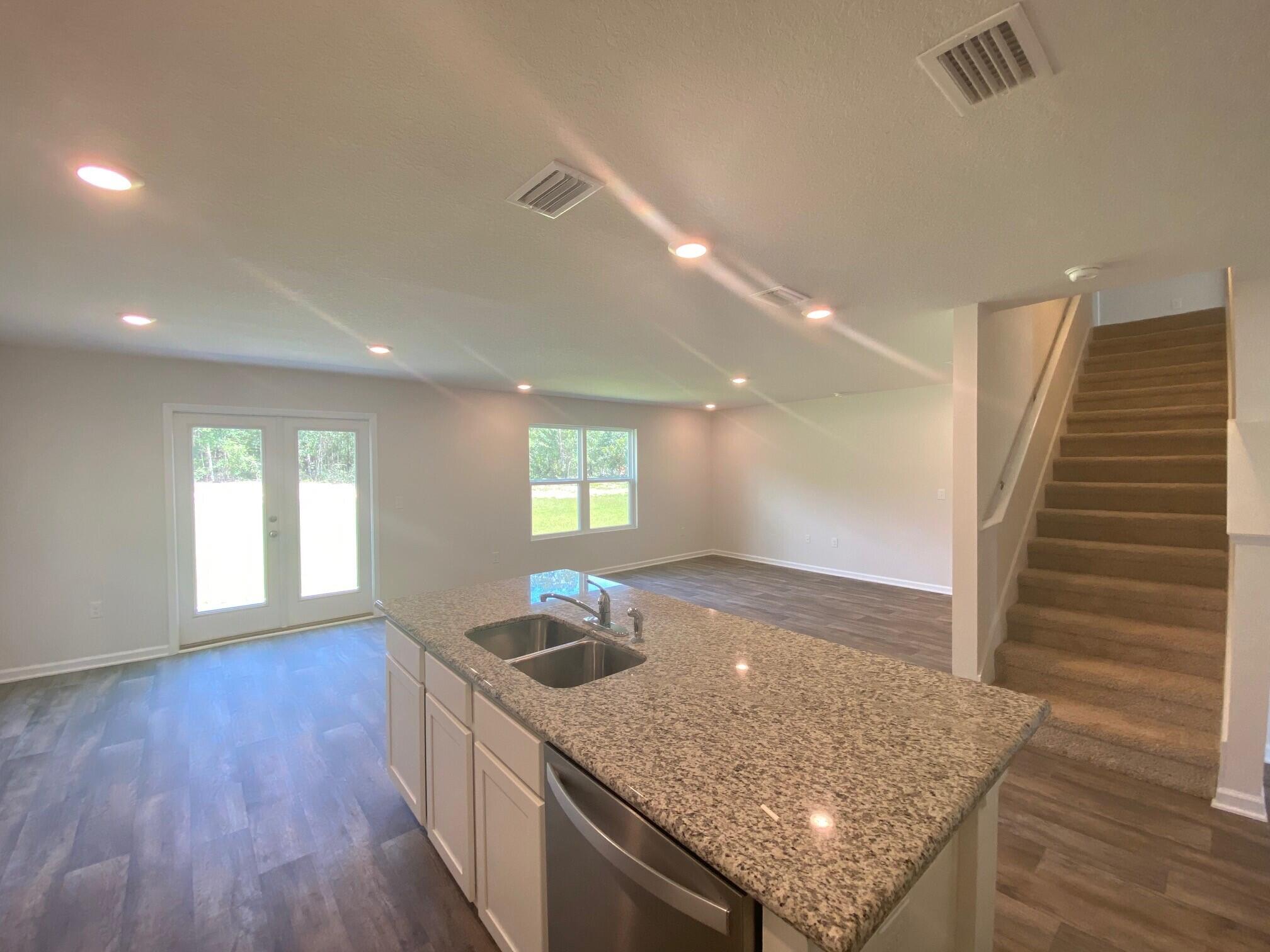 2861 Patriots Rdg Drive Crestview, FL 32539 - Photo 8 of 20 a kitchen with stainless steel appliances granite countertop a sink a stove and wooden floor
