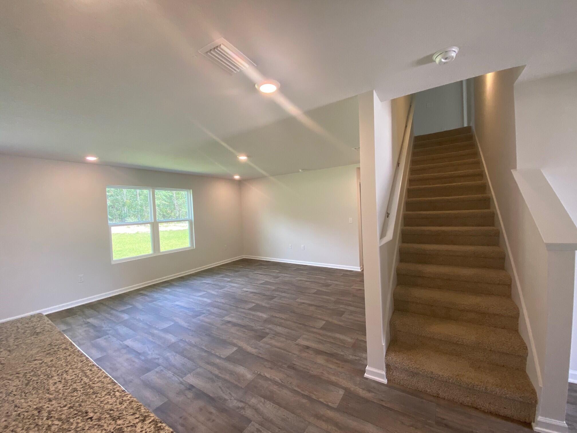 2861 Patriots Rdg Drive Crestview, FL 32539 - Photo 9 of 20 wooden floor in an empty room with windows