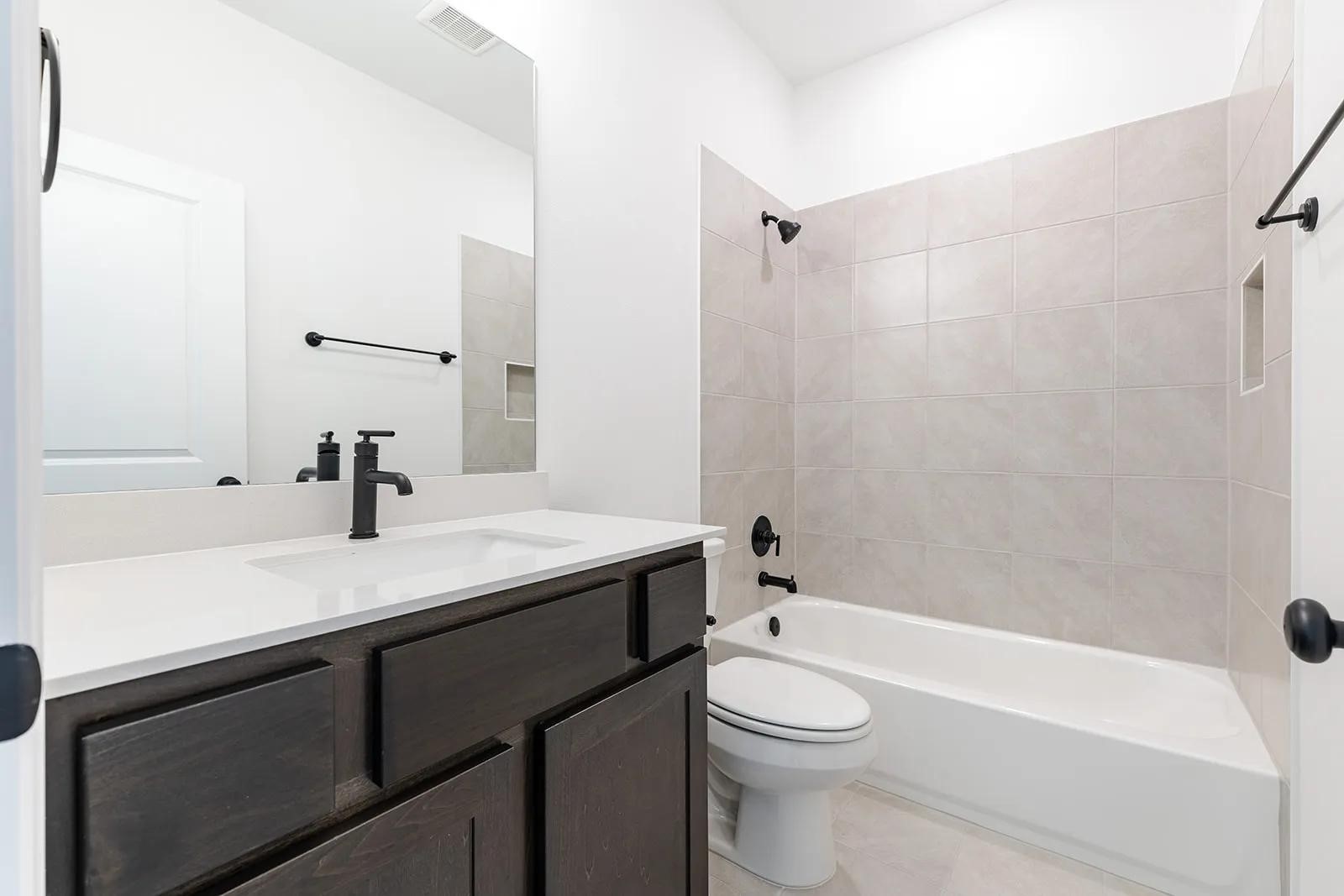 308 Buckaroo Drive Georgetown, TX 78633 - Photo 16 of 31 a bathroom with a sink a toilet and shower