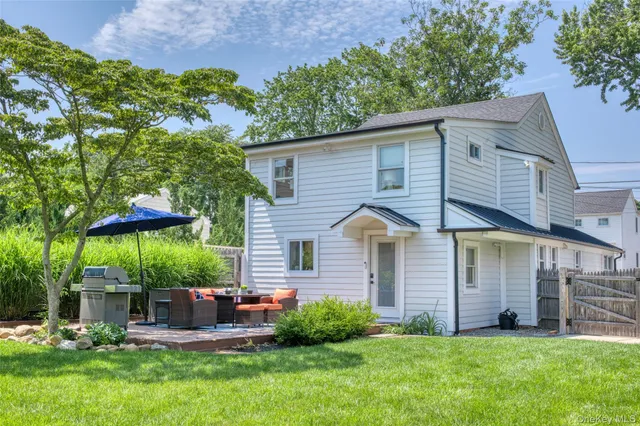 a view of a house with a yard and sitting area