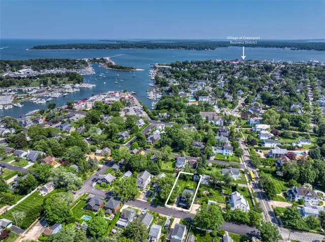 an aerial view of a houses with a yard