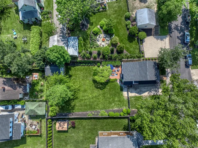 an aerial view of a house with garden space and street view