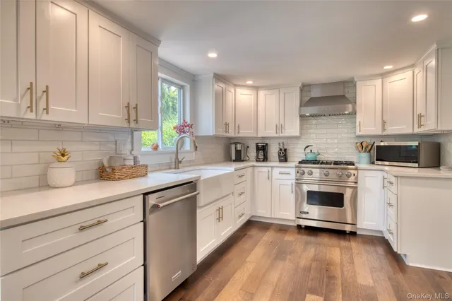a kitchen with a white cabinets and white appliances