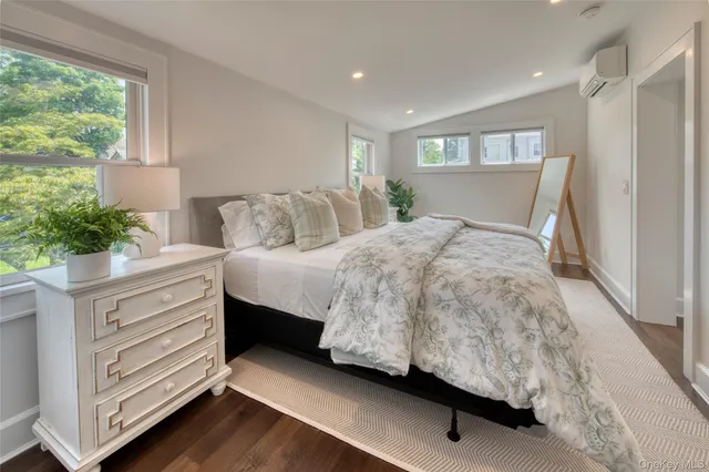 a bedroom with a bed and a potted plant