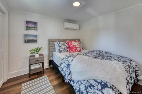 a bedroom with a bed and a painting on the wall