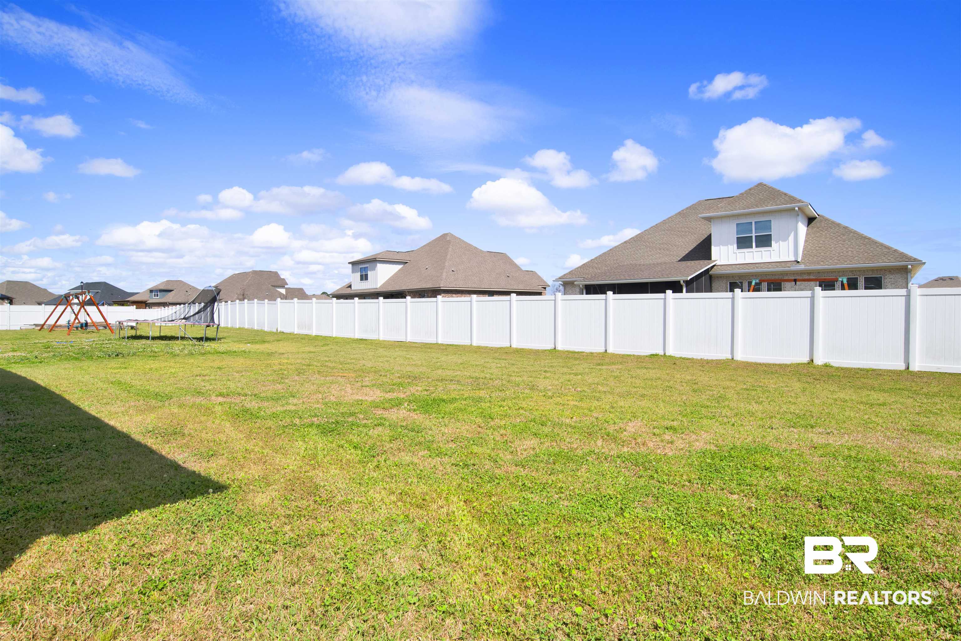 24253 Alydar Loop Daphne, AL 36526 - Photo 42 of 44 Fenced backyard featuring a residential view and a trampoline