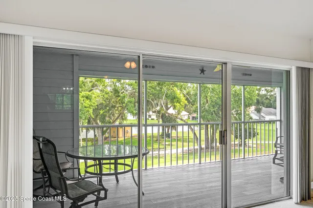a view of a room with furniture and floor to ceiling window