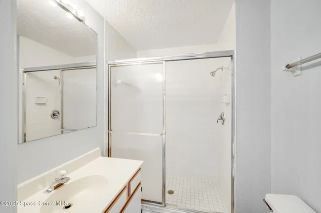 a bathroom with a sink a mirror and a shower