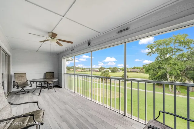 a view of a living room with furniture window and wooden floor