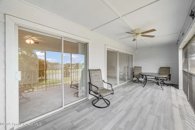a view of a room with gym equipment and floor to ceiling window