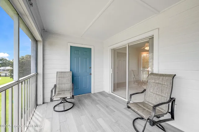 a view of a room with wooden floor and windows