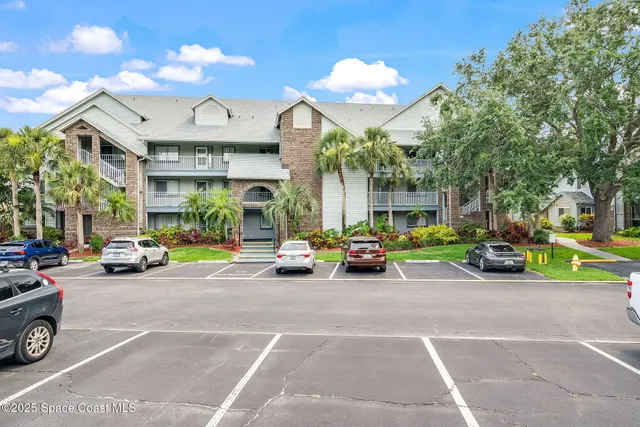 a view of a cars park in front of a building