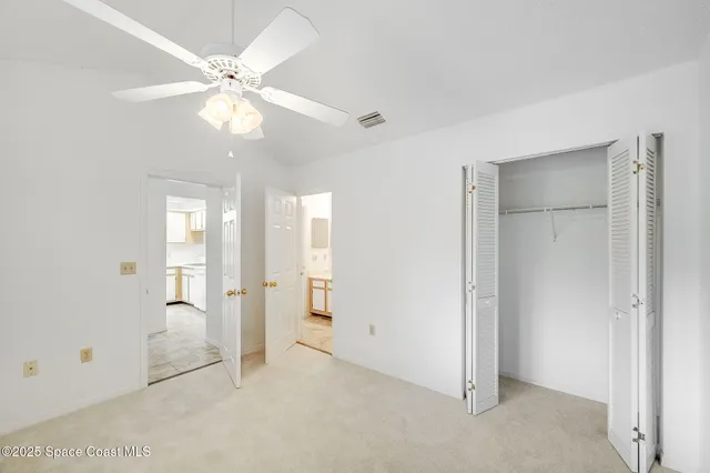 an empty room with fan and entrance