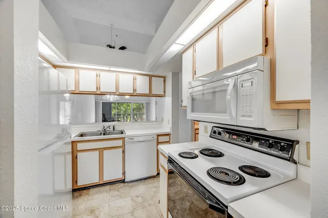 a kitchen with a stove a sink and a window