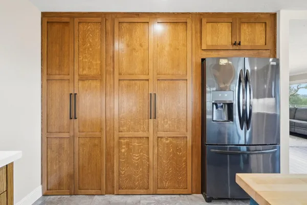 an empty room with a ceiling fan and window