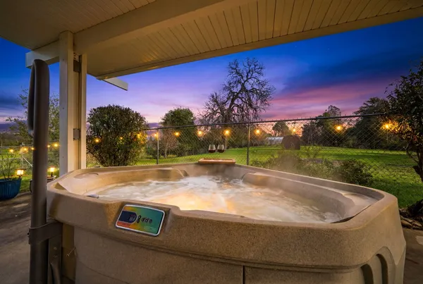 a backyard of a house with barbeque oven table and chairs