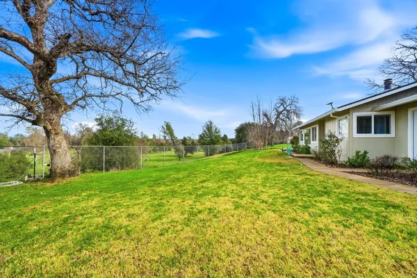 a view of a patio with table and chairs under an umbrella