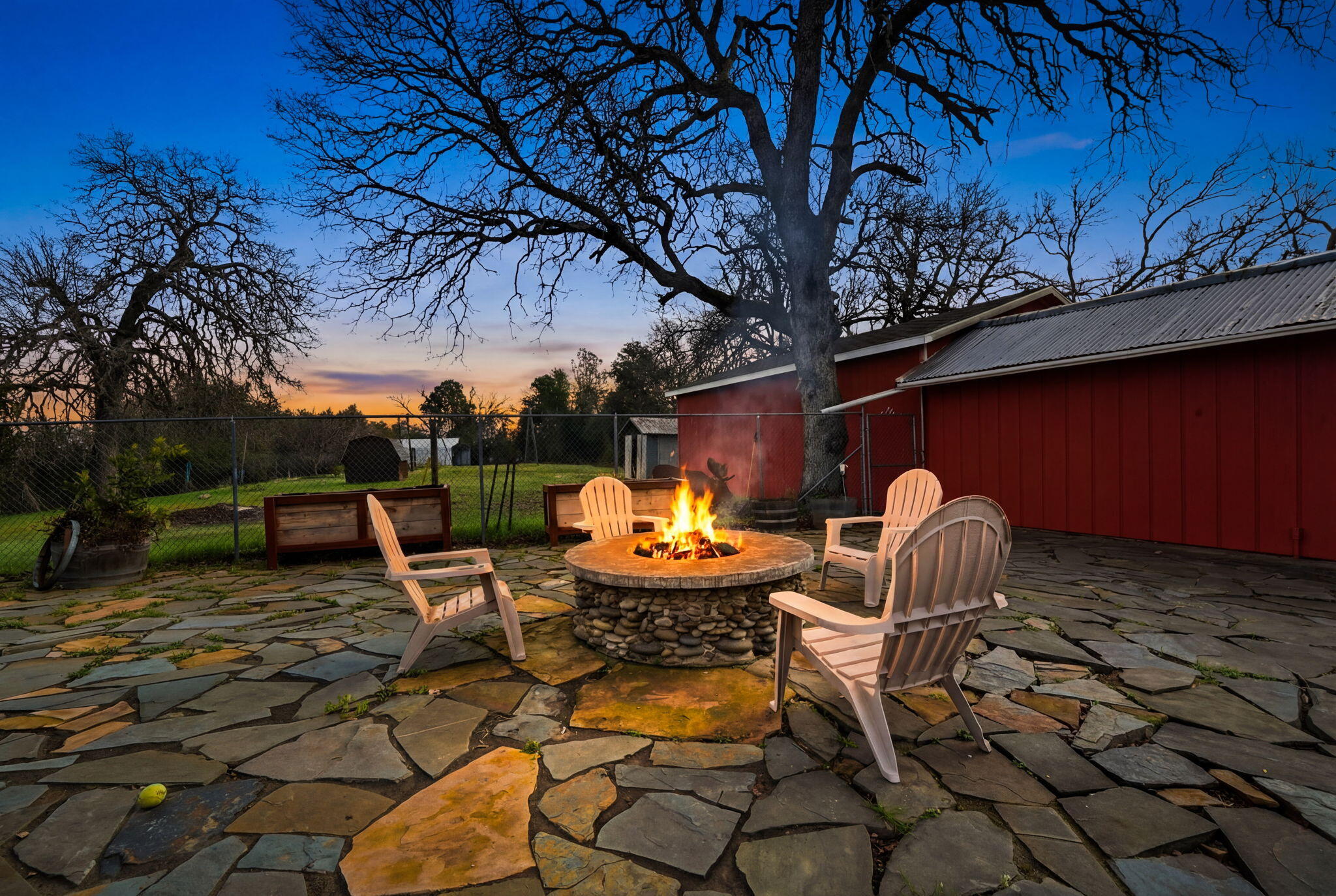 19690 Harp Road Cottonwood, CA 96022 - Photo 3 of 97 a backyard of a house with barbeque oven table and chairs