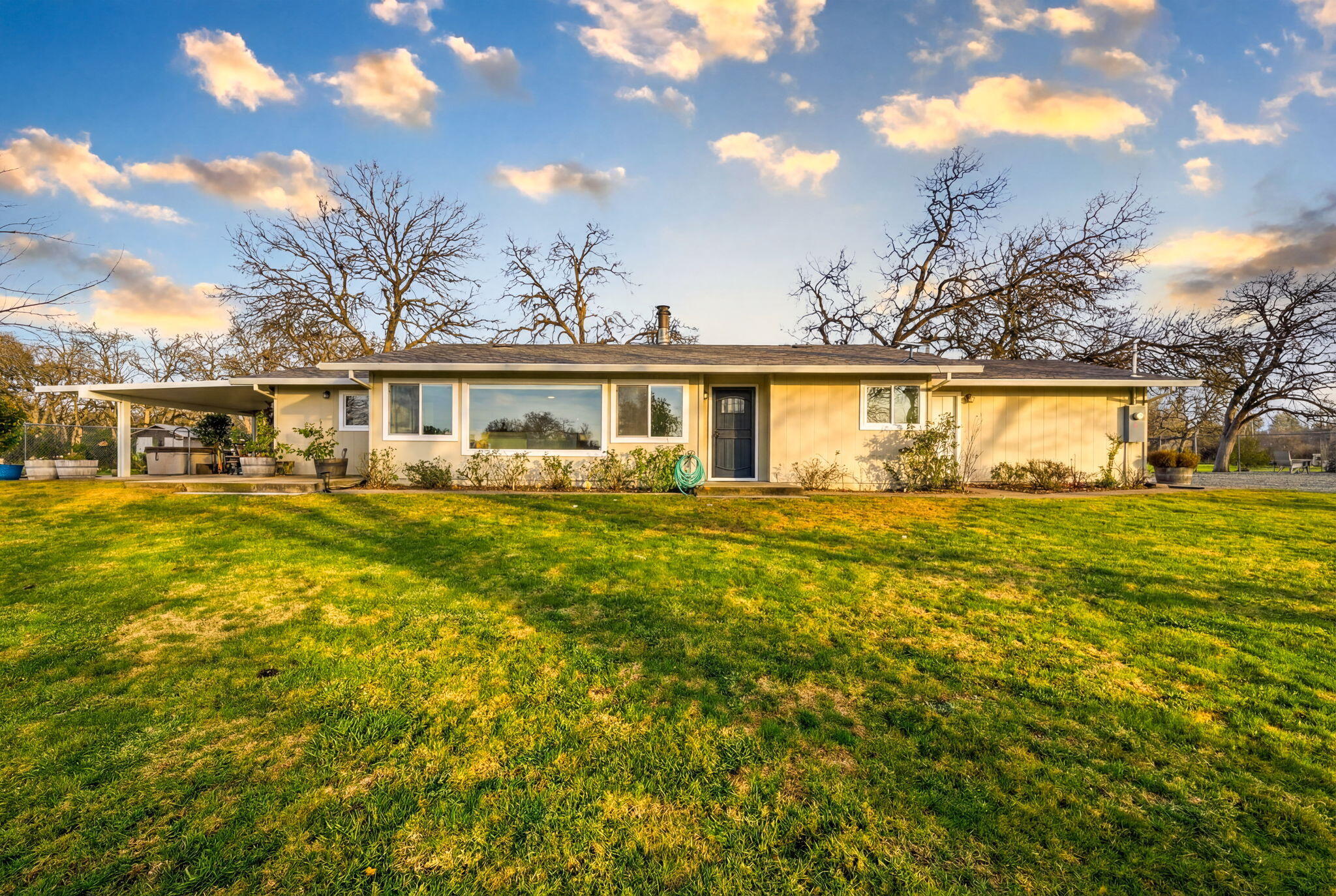 19690 Harp Road Cottonwood, CA 96022 - Photo 4 of 97 a front view of a house with a big yard