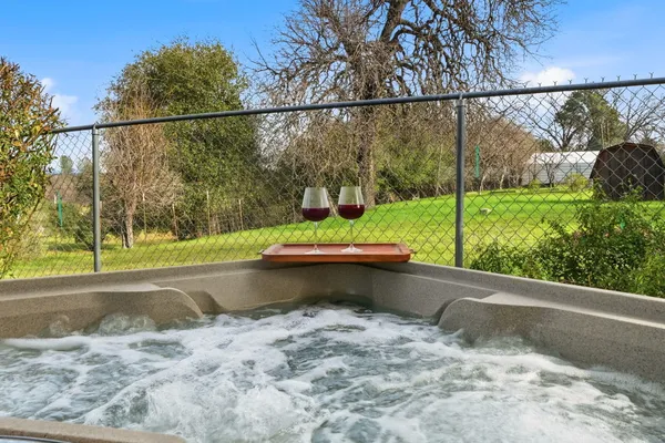 an aerial view of residential houses with outdoor space and trees