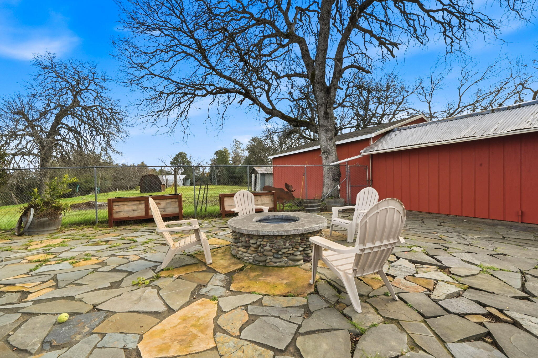 19690 Harp Road Cottonwood, CA 96022 - Photo 42 of 97 a view of a patio with table and chairs under an umbrella