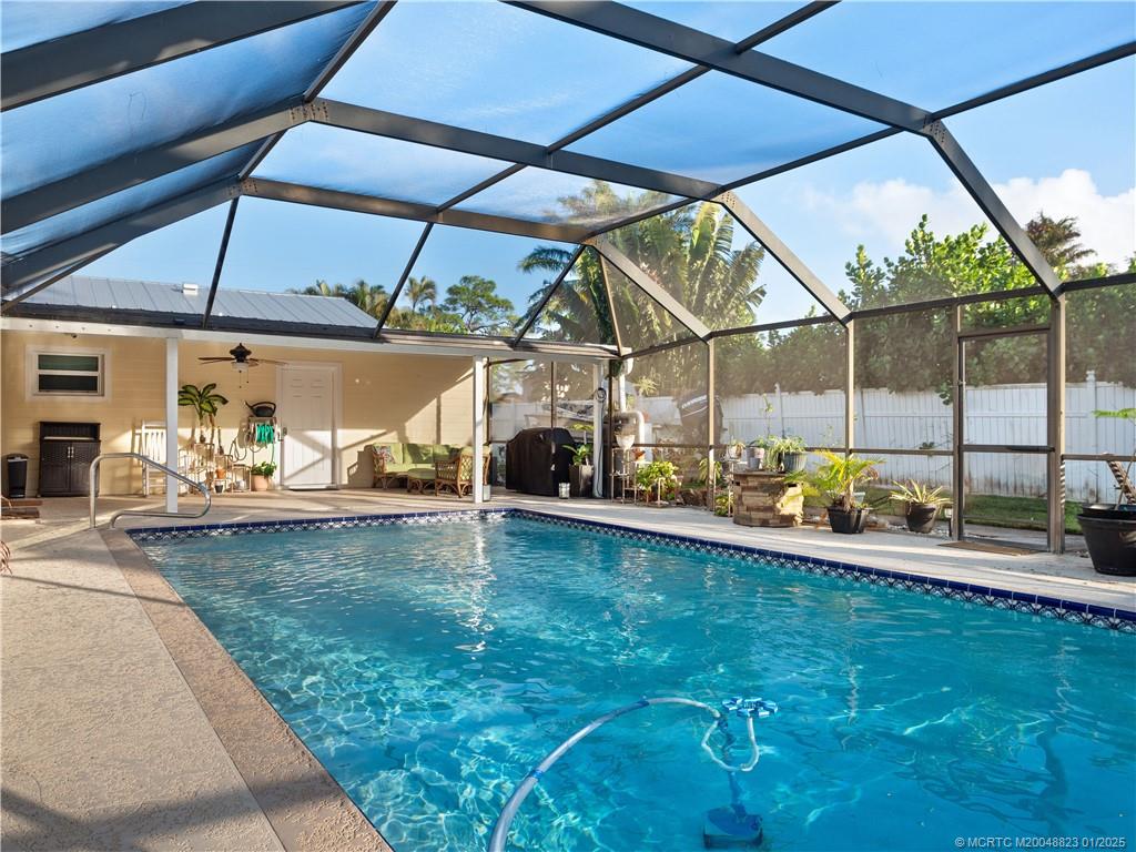 1544 Northwest Spruce Ridge Drive Stuart, FL 34994 - Photo 1 of 23 a view of a backyard with a patio and a yard