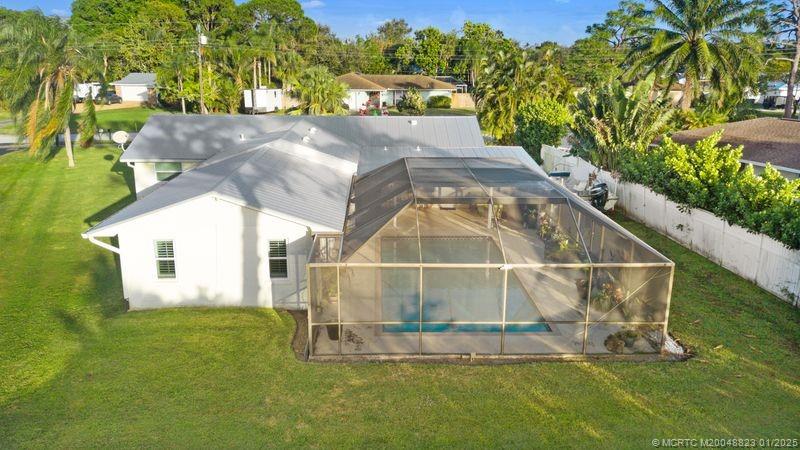 1544 Northwest Spruce Ridge Drive Stuart, FL 34994 - Photo 20 of 23 a backyard of a house with table and chairs