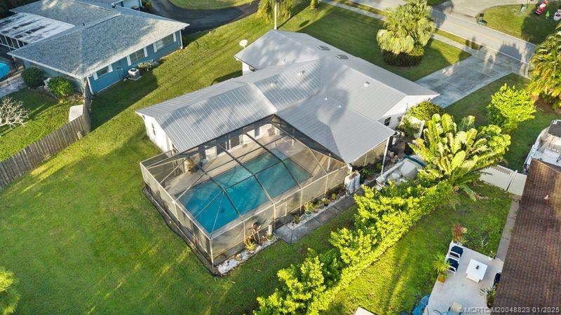 1544 Northwest Spruce Ridge Drive Stuart, FL 34994 - Photo 2 of 23 an aerial view of a house with a garden